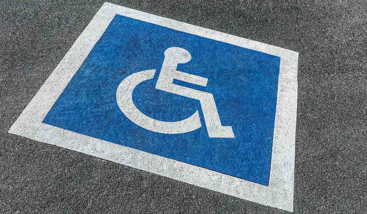 ADA-compliant handicap parking markings with blue and white accessibility symbol painted on asphalt in Baton Rouge, Louisiana